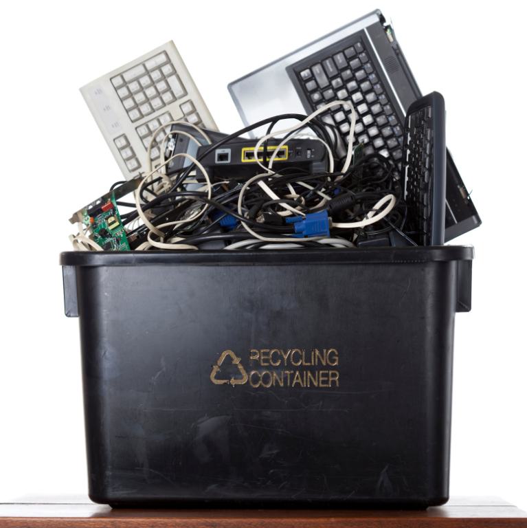 a black recycling container filled with old computer equipment