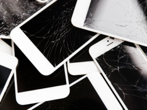 a pile of broken iPhones and iPads that should be recycled 