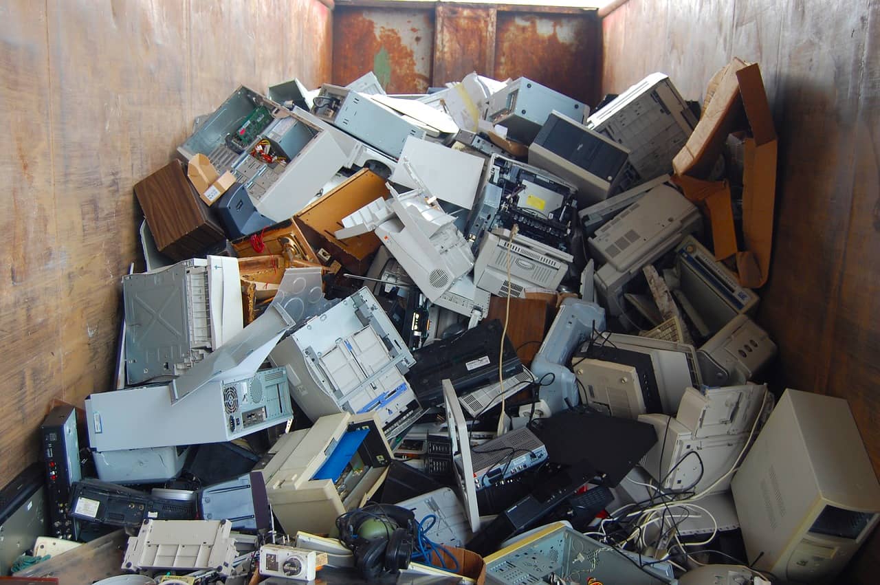 A pile of discarded electronics devices containing harmful hazardous waste substances.