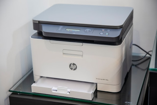 an HP printer with the loading tray open