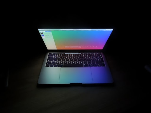 a modern-day laptop, open and glowing