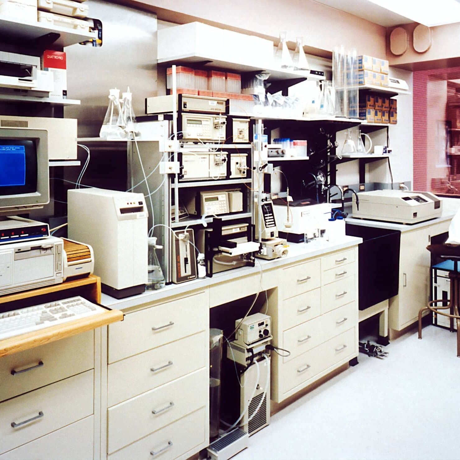 Interior of a medical lab with testing equipment and computer units on the shelves